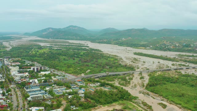 SAN JOSE DEL CABO BCS MEXICO-2021: Rising River Water near a Bridge and Green Landscape