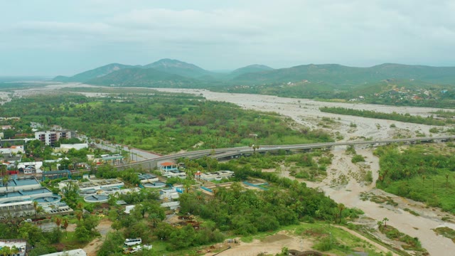SAN JOSE DEL CABO BCS MEXICO-2021: Vehicle Crossing Bridge Over Muddy River
