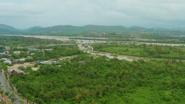SAN JOSE DEL CABO BCS MEXICO-2021: River Winding Through Lush Green Valley with Distant Hills