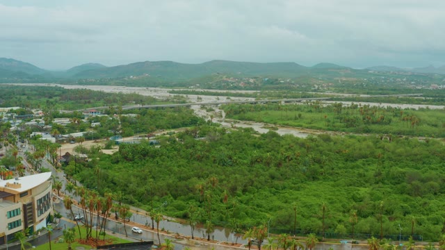 SAN JOSE DEL CABO BCS MEXICO-2021: Car Traveling on Road Through Lush Green Landscape