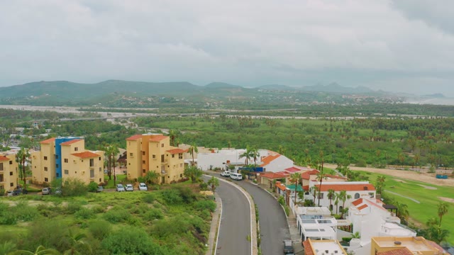 SAN JOSE DEL CABO BCS MEXICO-2021: Residential Neighborhood with Curving Road and Distant Mountains