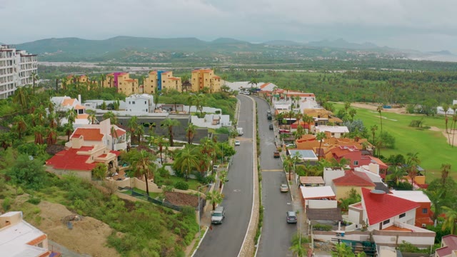 SAN JOSE DEL CABO BCS MEXICO-2021: Residential Street with Palm Trees and Moving Vehicles
