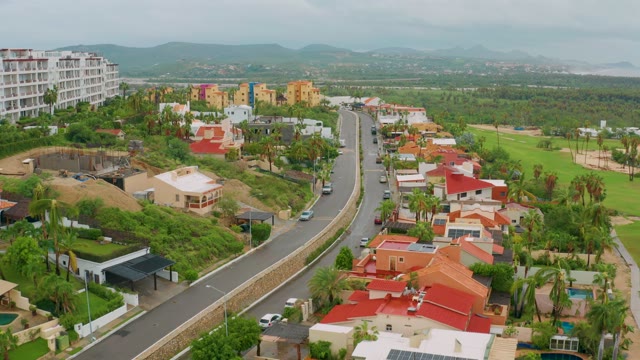 SAN JOSE DEL CABO BCS MEXICO-2021: Vehicles Moving on Residential Road with Golf Course