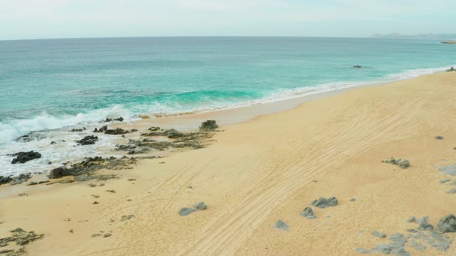 LAGUNA BEACH LOS CABOS BCS MEXICO-2021: Waves Crashing on Rocky Shore with Sandy Beach