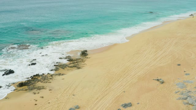 LAGUNA BEACH LOS CABOS BCS MEXICO-2021: Ocean Waves Rolling Onto Sandy Shore