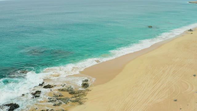 LAGUNA BEACH LOS CABOS BCS MEXICO-2021: Gentle Ocean Waves Receding on Sandy Shore