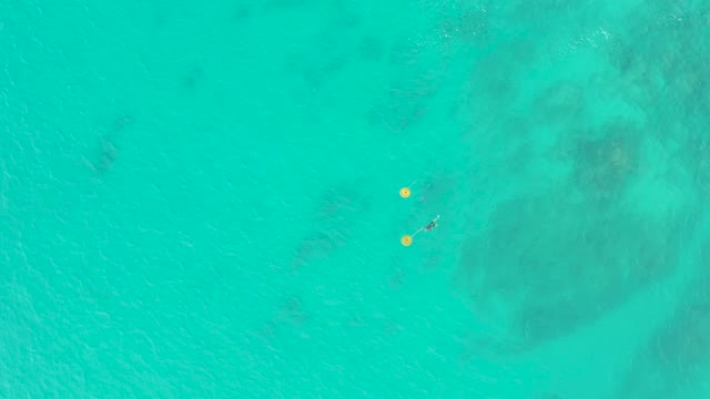 LAGUNA BEACH LOS CABOS BCS MEXICO-2021: Swimmer and Buoys Drifting in Turquoise Water