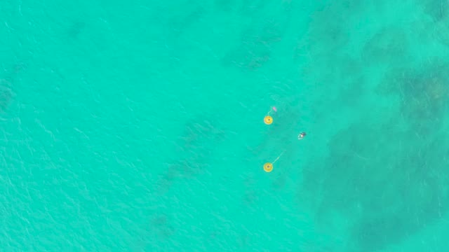 LAGUNA BEACH LOS CABOS BCS MEXICO-2021: Person Swimming near Yellow Buoys in Clear Ocean Water