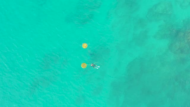 LAGUNA BEACH LOS CABOS BCS MEXICO-2021: People Swimming Near Yellow Buoys in Turquoise Water