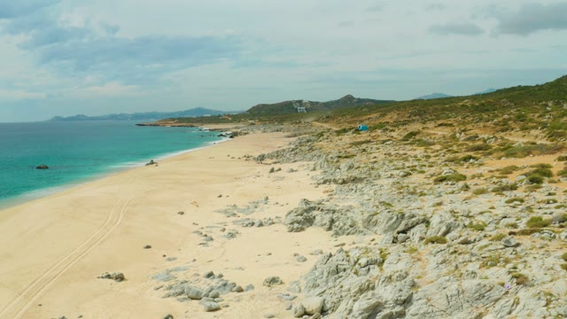 LAGUNA BEACH LOS CABOS BCS MEXICO-2021: Sandy Beach with Boat Moving Along Shore