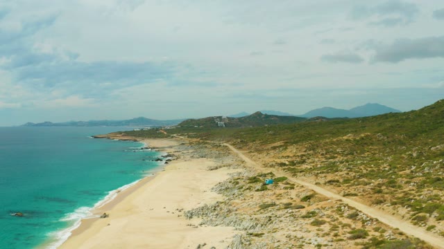 LAGUNA BEACH LOS CABOS BCS MEXICO-2021: Coastal Beach and Path with Moving Figure and Shifting Clouds