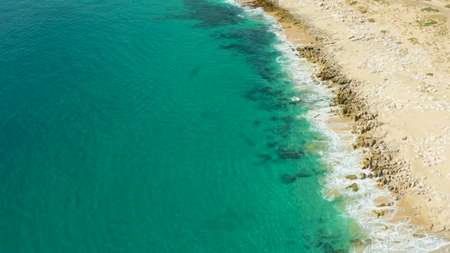 LAGUNA BEACH LOS CABOS BCS MEXICO-2021: Ocean Waves Lapping Rocky Sandy Shore