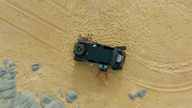 LAGUNA BEACH LOS CABOS BCS MEXICO-2021: A Person near a 4x4 Vehicle in Sandy Desert Terrain