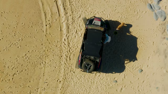 LAGUNA BEACH LOS CABOS BCS MEXICO-2021: SUV with Person and Dog Moving on Desert Sand