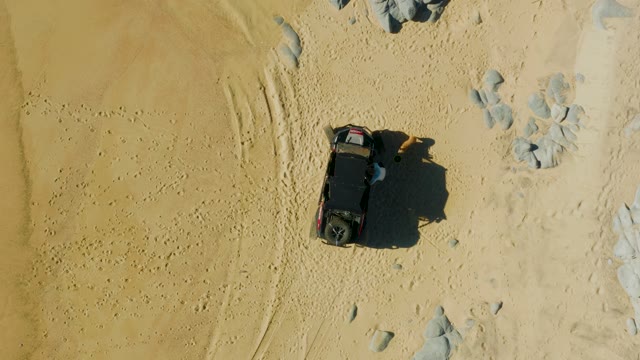 LAGUNA BEACH LOS CABOS BCS MEXICO-2021: SUV and Person Moving on Sandy Terrain