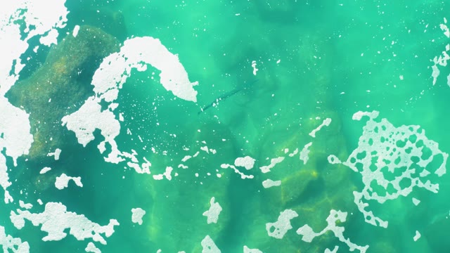 LAGUNA BEACH LOS CABOS BCS MEXICO-2021: Turquoise Water Surface with Shifting White Foam Patches