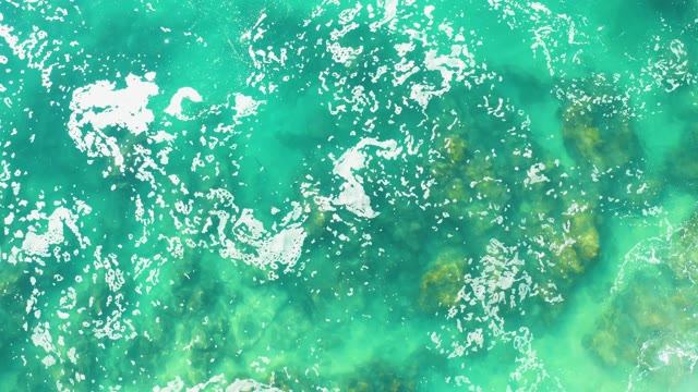 LAGUNA BEACH LOS CABOS BCS MEXICO-2021: Shifting Seafoam on Turquoise Ocean Surface