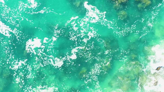 LAGUNA BEACH LOS CABOS BCS MEXICO-2021: Ocean Waves Over Rocky Seabed in Clear Turquoise Water