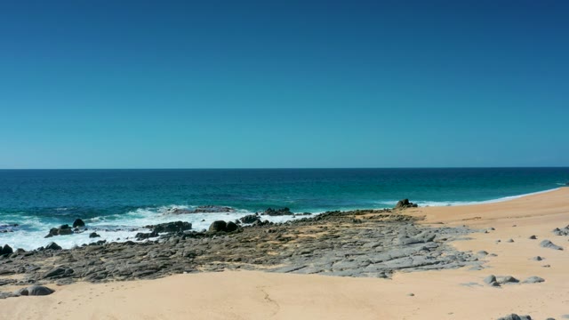 LAGUNA BEACH LOS CABOS BCS MEXICO-2021: Vehicle Approaching Sandy Beach with Ocean Waves