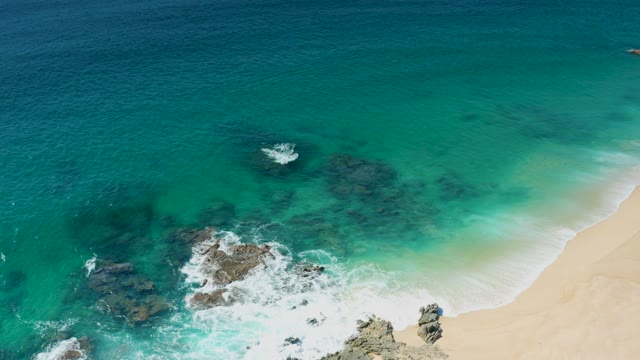 LAGUNA BEACH LOS CABOS BCS MEXICO-2021: Waves Crashing Against Rocky Shoreline with Turquoise Water