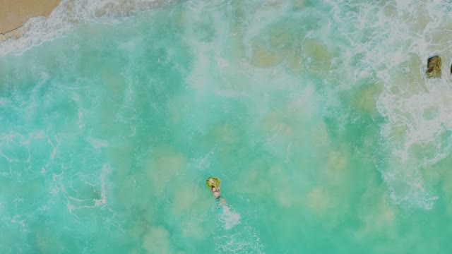 LAGUNA BEACH LOS CABOS BCS MEXICO-2021: Person Floating on a Yellow Float near the Shore