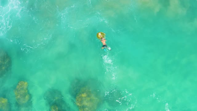 LAGUNA BEACH LOS CABOS BCS MEXICO-2021: Person Swimming with Inflatable Ring in Clear Ocean Water