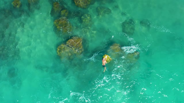 LAGUNA BEACH LOS CABOS BCS MEXICO-2021: Person Swimming in Clear Turquoise Water with Rocks