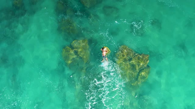 LAGUNA BEACH LOS CABOS BCS MEXICO-2021: Person Swimming in Clear Turquoise Water Over Rocks