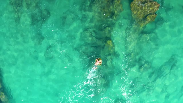 LAGUNA BEACH LOS CABOS BCS MEXICO-2021: Person Swimming in Clear Turquoise Ocean Water