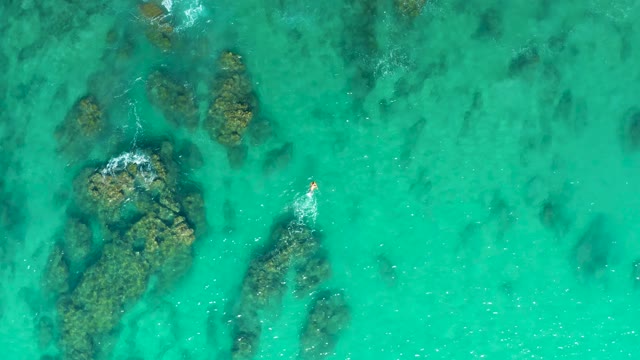 LAGUNA BEACH LOS CABOS BCS MEXICO-2021: A Person Floating on Clear Turquoise Water over Rocks