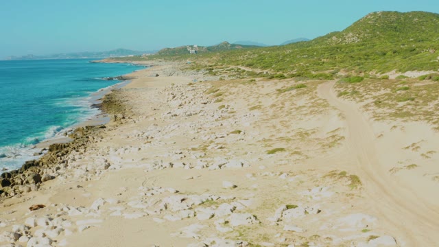 LAGUNA BEACH LOS CABOS BCS MEXICO-2021: Person Walking Along Sandy Beach by Ocean