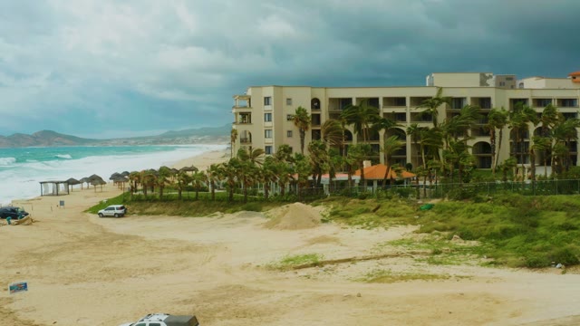 DREAMS RESORT LOS CABOS BCS MEXICO-2021: Beachfront Hotel, Palm Trees, and Car Driving on Sandy Road