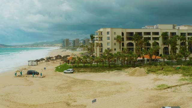 DREAMS RESORT LOS CABOS BCS MEXICO-2021: Beachgoer Moving near Small Structure on Sandy Shore