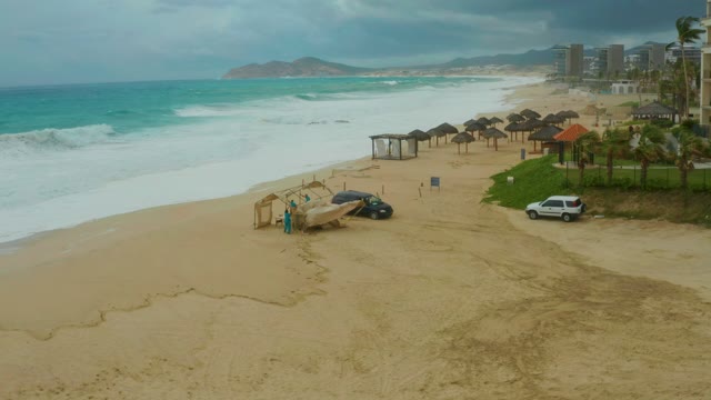 DREAMS RESORT LOS CABOS BCS MEXICO-2021: Waves Crashing on Sandy Beach with Parked Cars