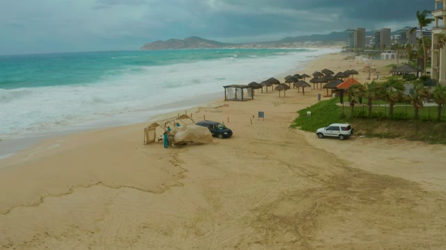 DREAMS RESORT LOS CABOS BCS MEXICO-2021: Sandy Beach with Crashing Waves and Parked Vehicles