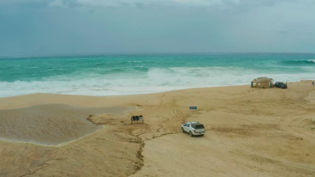 DREAMS RESORT LOS CABOS BCS MEXICO-2021: SUV Driving on Sandy Beach with Ocean Waves