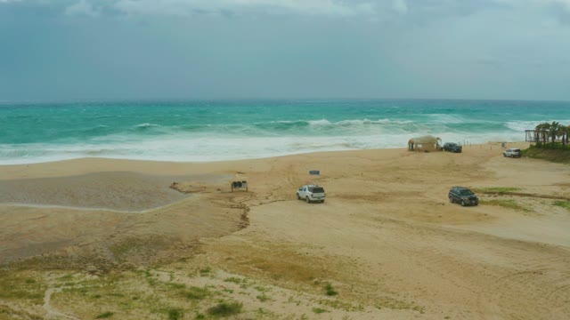 DREAMS RESORT LOS CABOS BCS MEXICO-2021: Vehicles on Sandy Beach with Ocean Waves