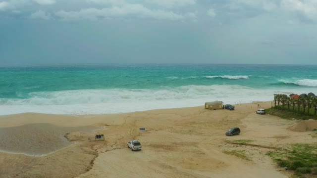 DREAMS RESORT LOS CABOS BCS MEXICO-2021: Waves Crashing on Sandy Beach with Parked Vehicles