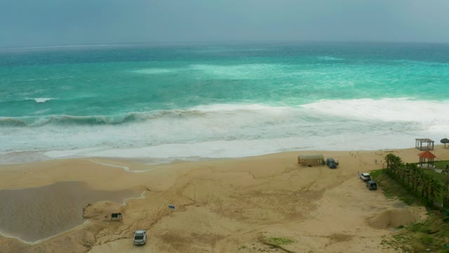 DREAMS RESORT LOS CABOS BCS MEXICO-2021: Waves Crashing on Sandy Shore with Parked Vehicles