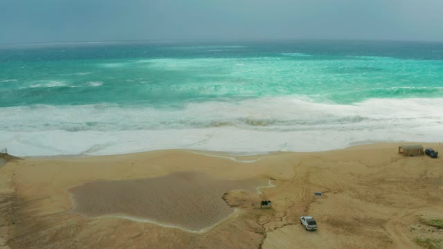 DREAMS RESORT LOS CABOS BCS MEXICO-2021: Waves Crashing on Sandy Beach with Parked Vehicles