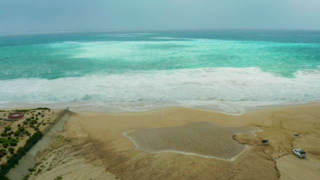 DREAMS RESORT LOS CABOS BCS MEXICO-2021: Waves Rolling Onto Sandy Beach with Turquoise Water
