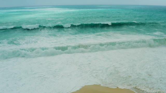DREAMS RESORT LOS CABOS BCS MEXICO-2021: Ocean Waves Rolling Onto a Sandy Beach