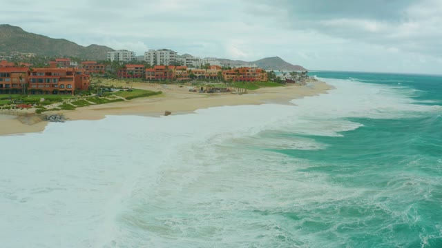 DREAMS RESORT LOS CABOS BCS MEXICO-2021: Waves Rolling Toward Sandy Beach Shoreline
