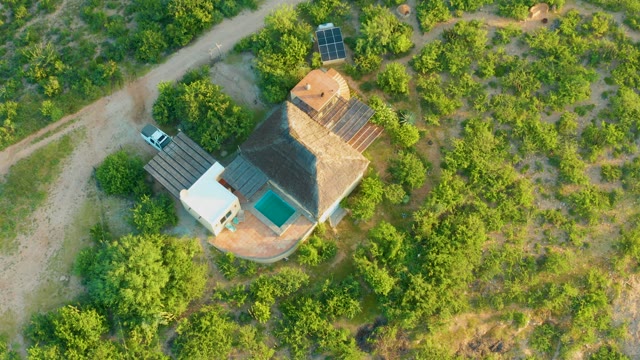 CABO PULMO BCS MEXICO-2021: Overhead View of House with Solar Panels in Tree-Covered Area