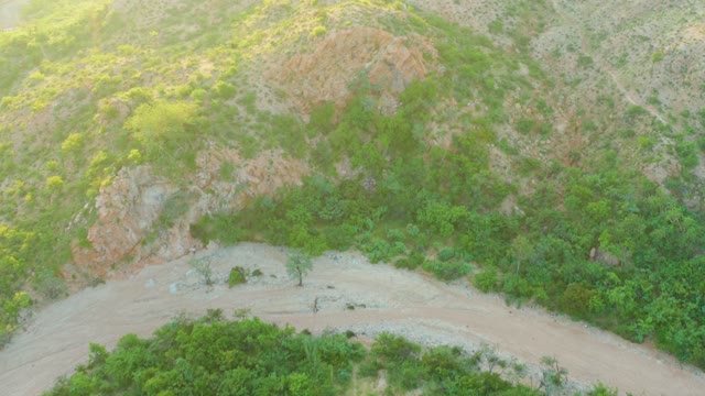 CABO PULMO BCS MEXICO-2021: Curved Dirt Road Through Hilly Green Landscape