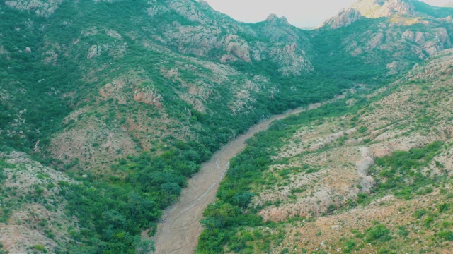 CABO PULMO BCS MEXICO-2021: River Winding Through Forested Mountain Valley