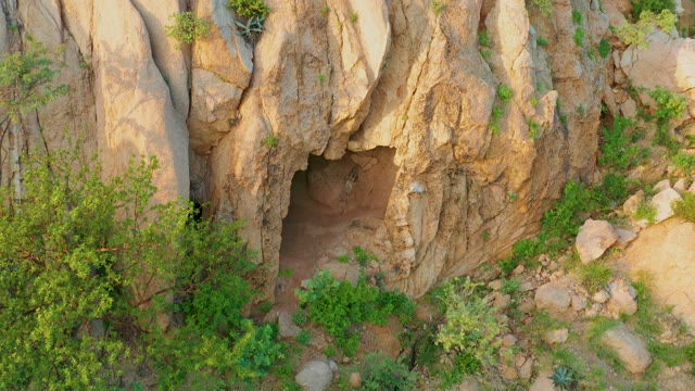 CABO PULMO BCS MEXICO-2021: Rocky Cave Entrance Amidst Green Vegetation