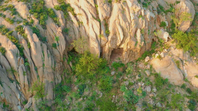 CABO PULMO BCS MEXICO-2021: Rocky Outcrop with Cave Entrance and Wind-swaying Vegetation