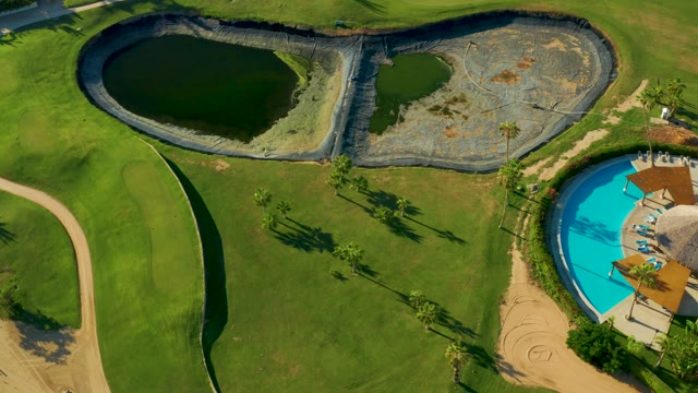 SAN JOSE DEL CABO BCS MEXICO-2021: Ponds and Pool with Palm Trees Moving Out of Frame