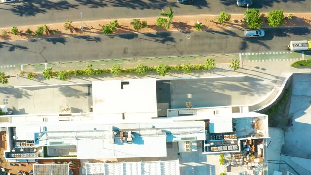 SAN JOSE DEL CABO BCS MEXICO-2021: City Street with Moving Vehicles and Surrounding Buildings